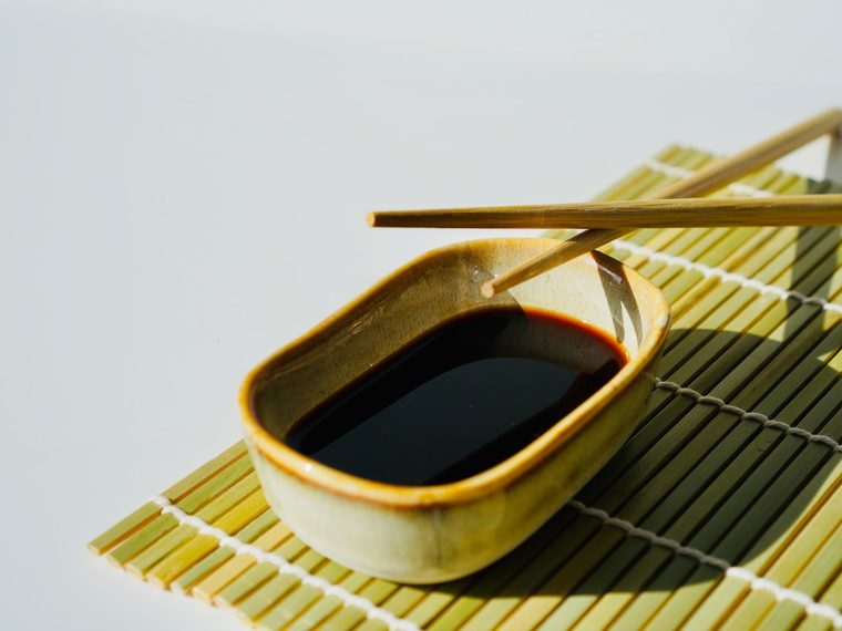 A dark fermented seasoning in a small ceramic dish